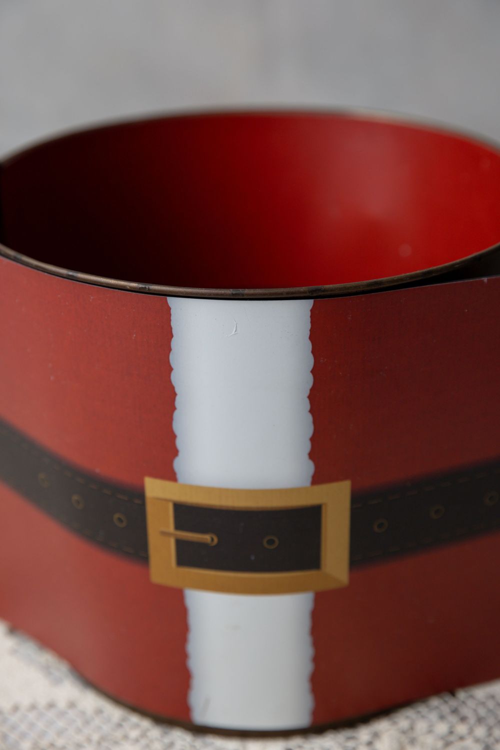 Red Santa Claus belt buckle Christmas bowl, festive holiday container with black belt and gold buckle design.