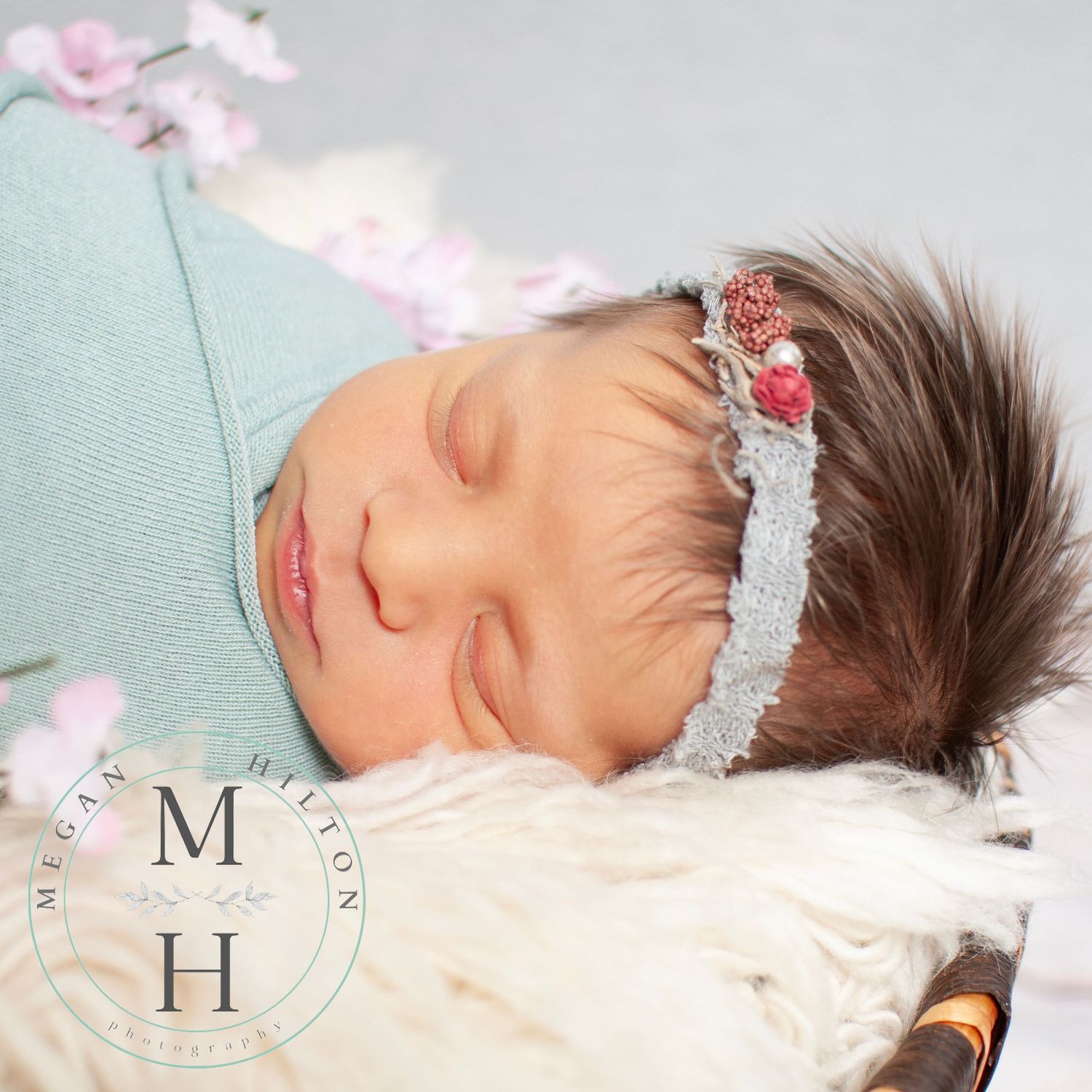 Sleeping newborn with handmade headband mint and pink