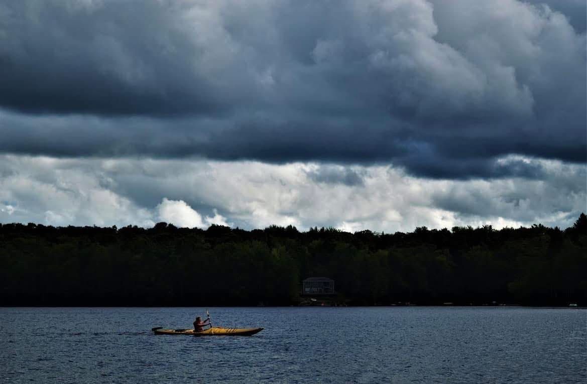 stormy sky with a person kayaking