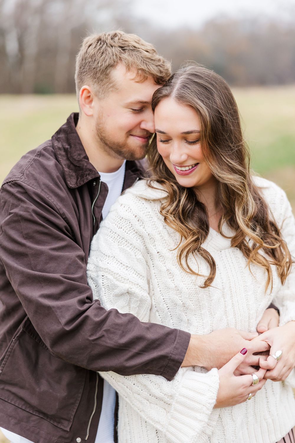 Intimate portrait of couple in warm winter clothing embracing outdoors.