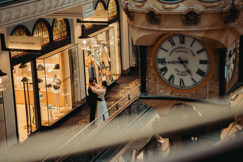 Intimate portrait in historic building with ornate clock and architectural details.