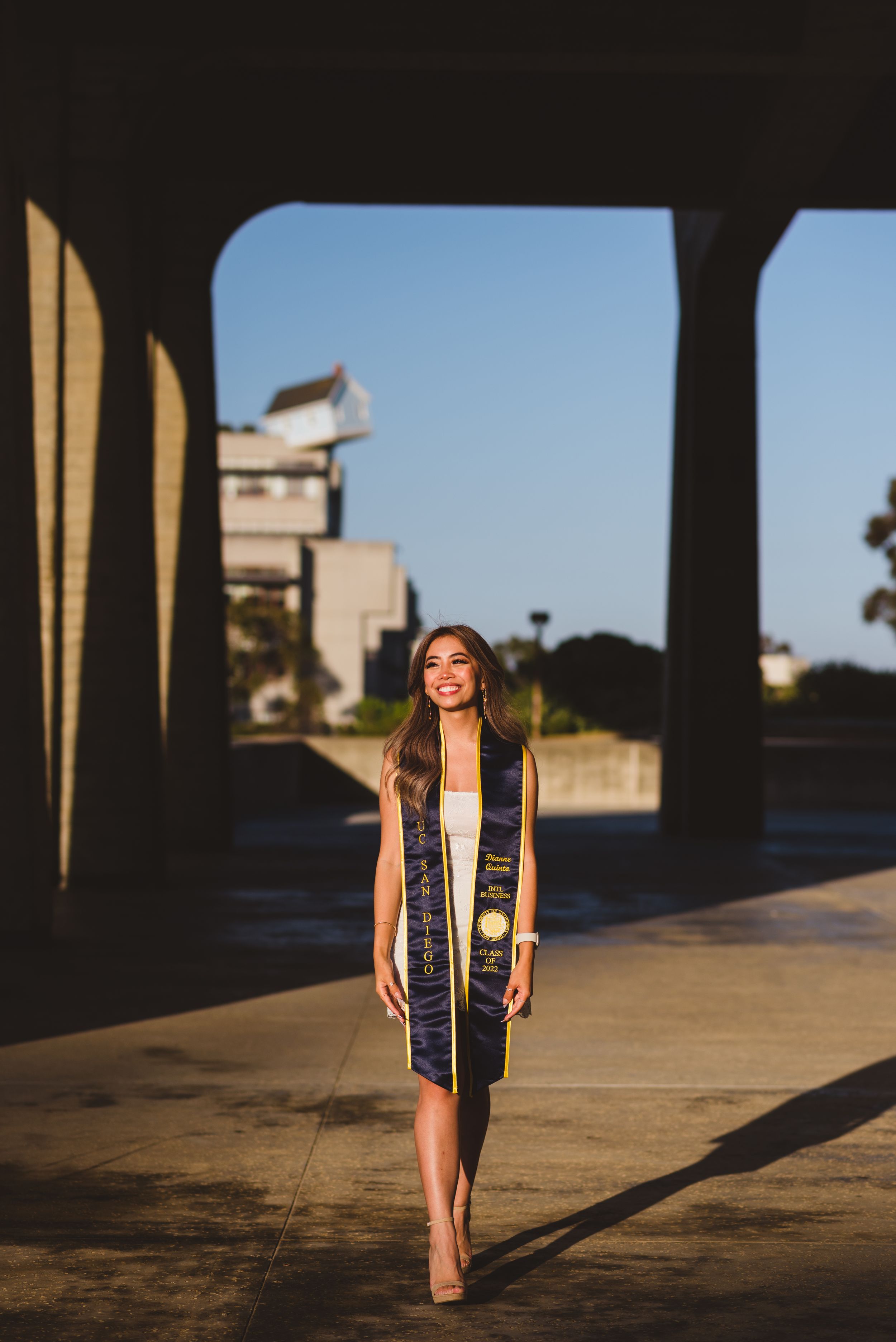 UC San Diego graduate posing for a photo looking to the side.