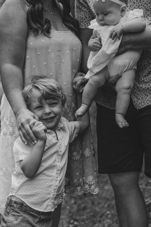 A sequence of five photos showing a small child laughing and being tickled by someone just out of frame.