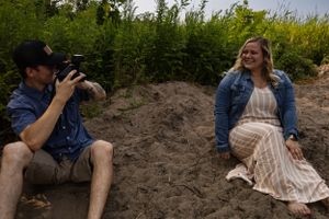 Behind the scenes of photographer taking pictures during outdoor photoshoot.