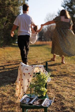 Pregnancy announcement in the field at golden hour