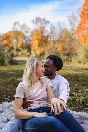 Multi racial couple enjoying the fall leaves