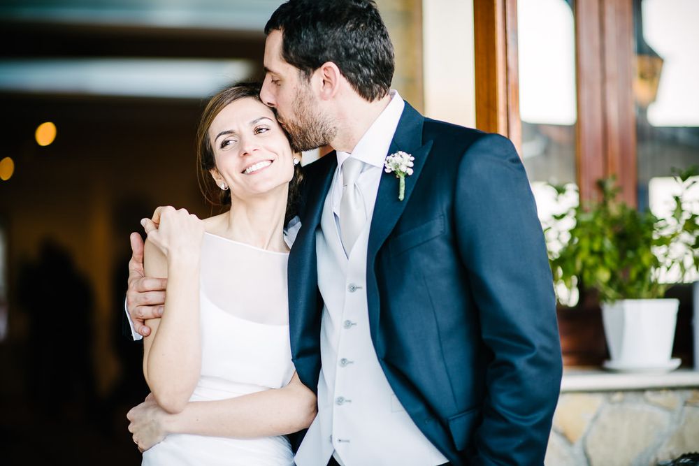 Candid wedding moments captured in warm indoor lighting.