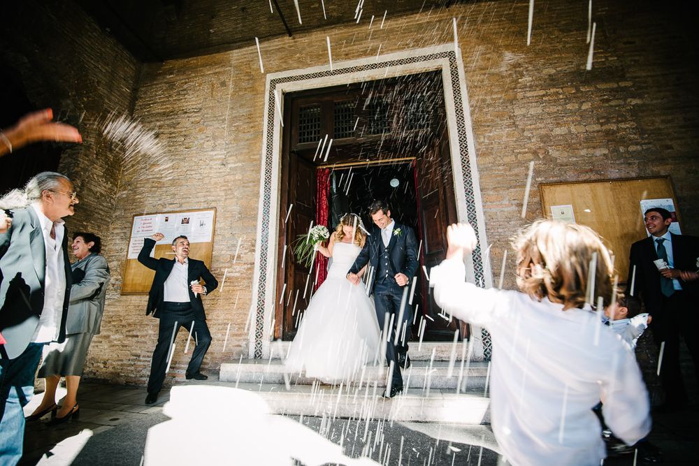Black and white photo series showing wedding guests celebrating in a rustic indoor venue.