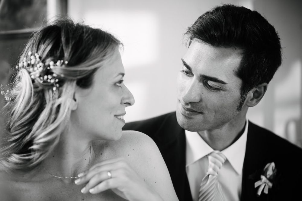 Intimate black and white close-up shots of a wedding couple sharing romantic moments.
