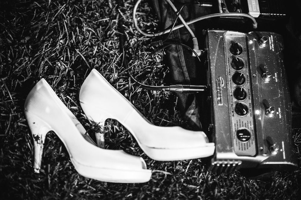 Artistic detail shots of white bridal shoes arranged with vintage decorative elements.