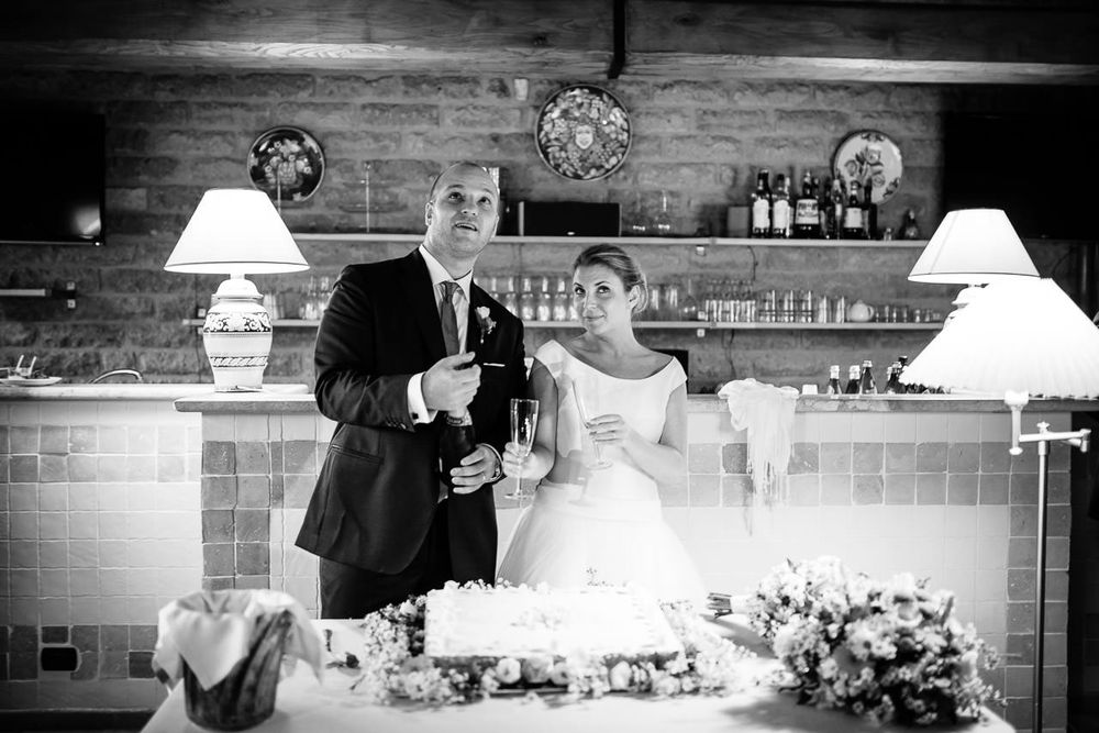 Intimate wedding reception setting with brick walls and pendant lighting.