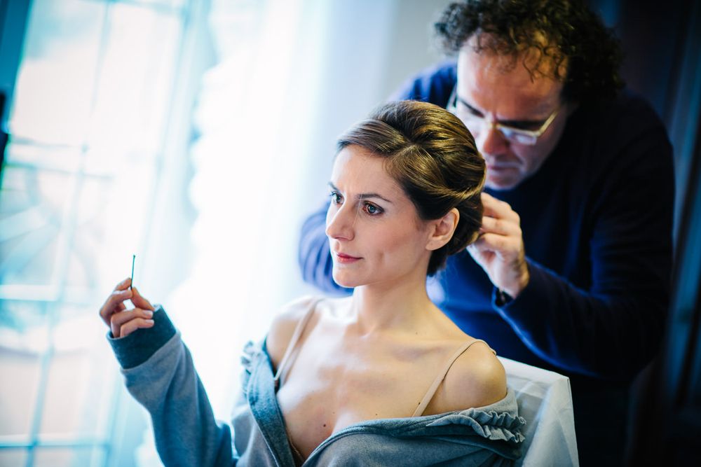 Getting ready scene in natural window light with blue tones.