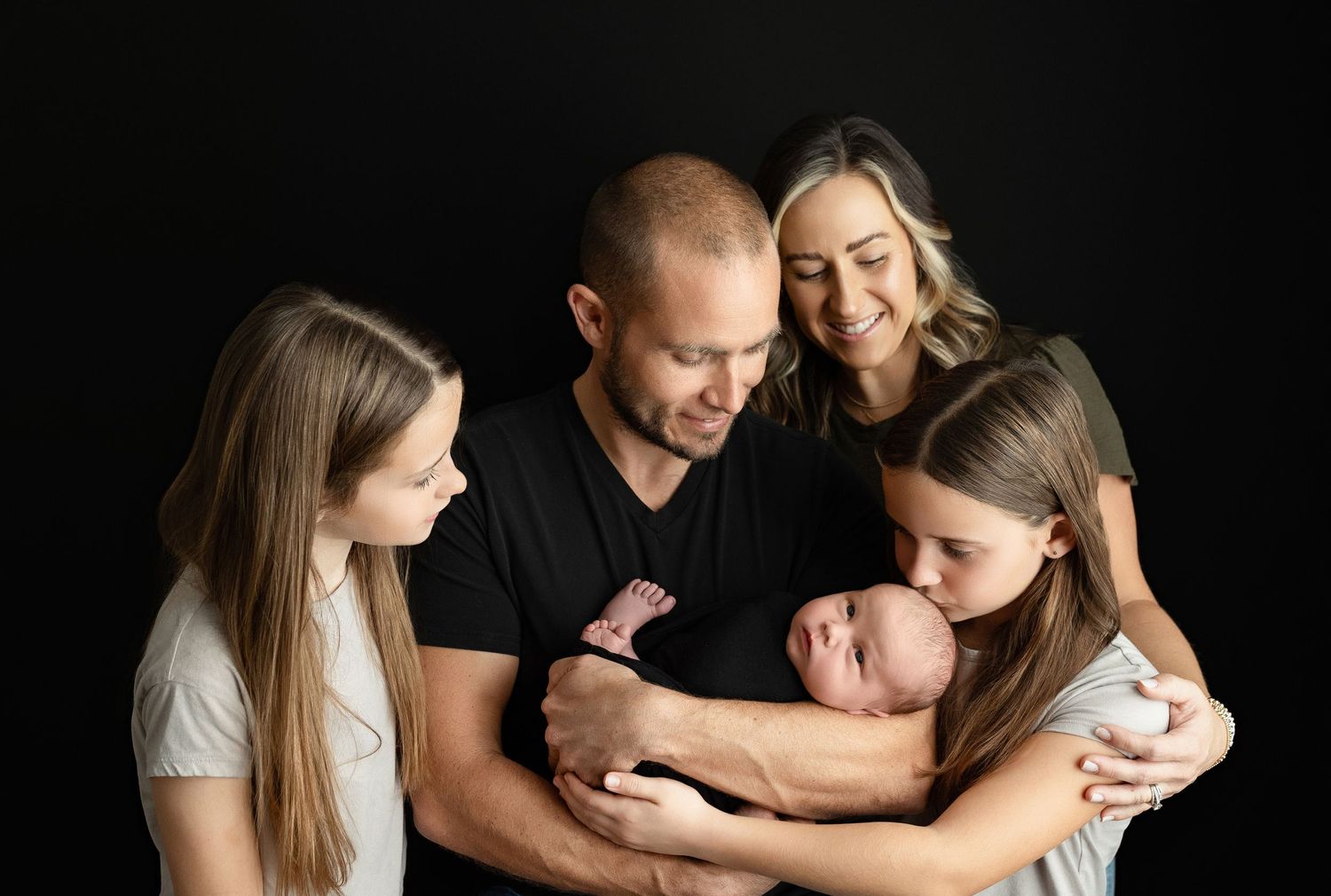 A large family holding a newborn and looking at him. Greenville SC newborn photographer, Easley, SC newborn photographer