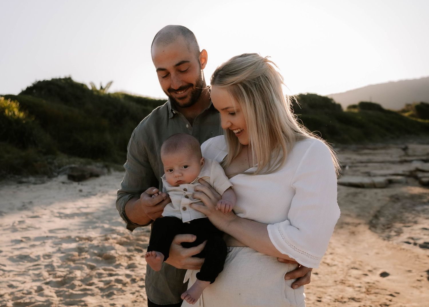 Newborn shoot at sunset, showing baby with loving parents in Woonona, newborn and baby photos in Woonona, Corrimal, Bulli and the Illawarra.