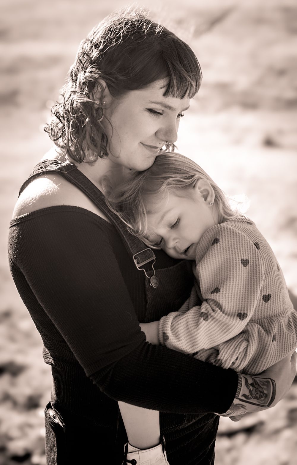a photo of mother and child smiling in a meadow