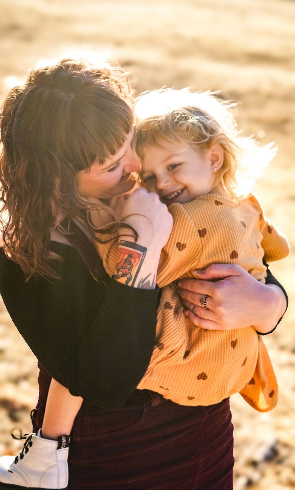 a photo of mother and child smiling in a meadow