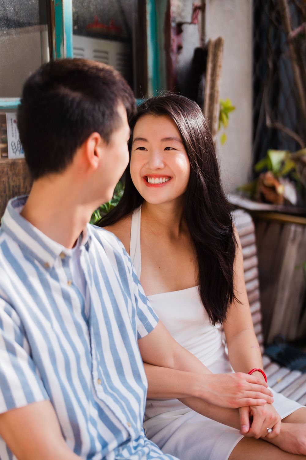 Intimate moment of a couple in front of a vintage grocery store at Dihua Street in Dadaocheng District.