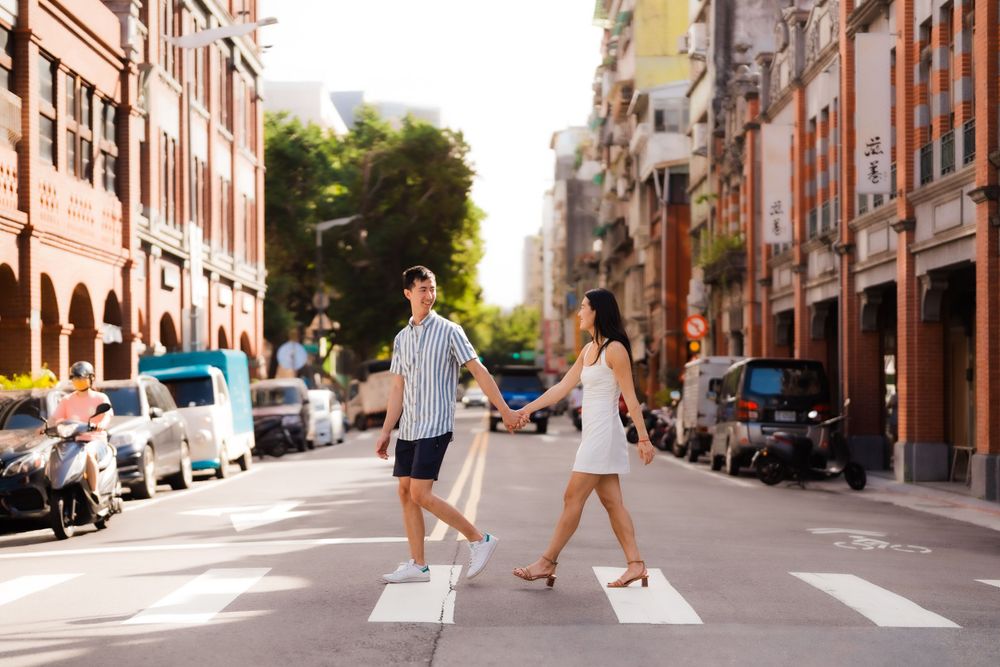 A couple crossing the streets of Dihua Street at Dadaocheng in Taipei City.