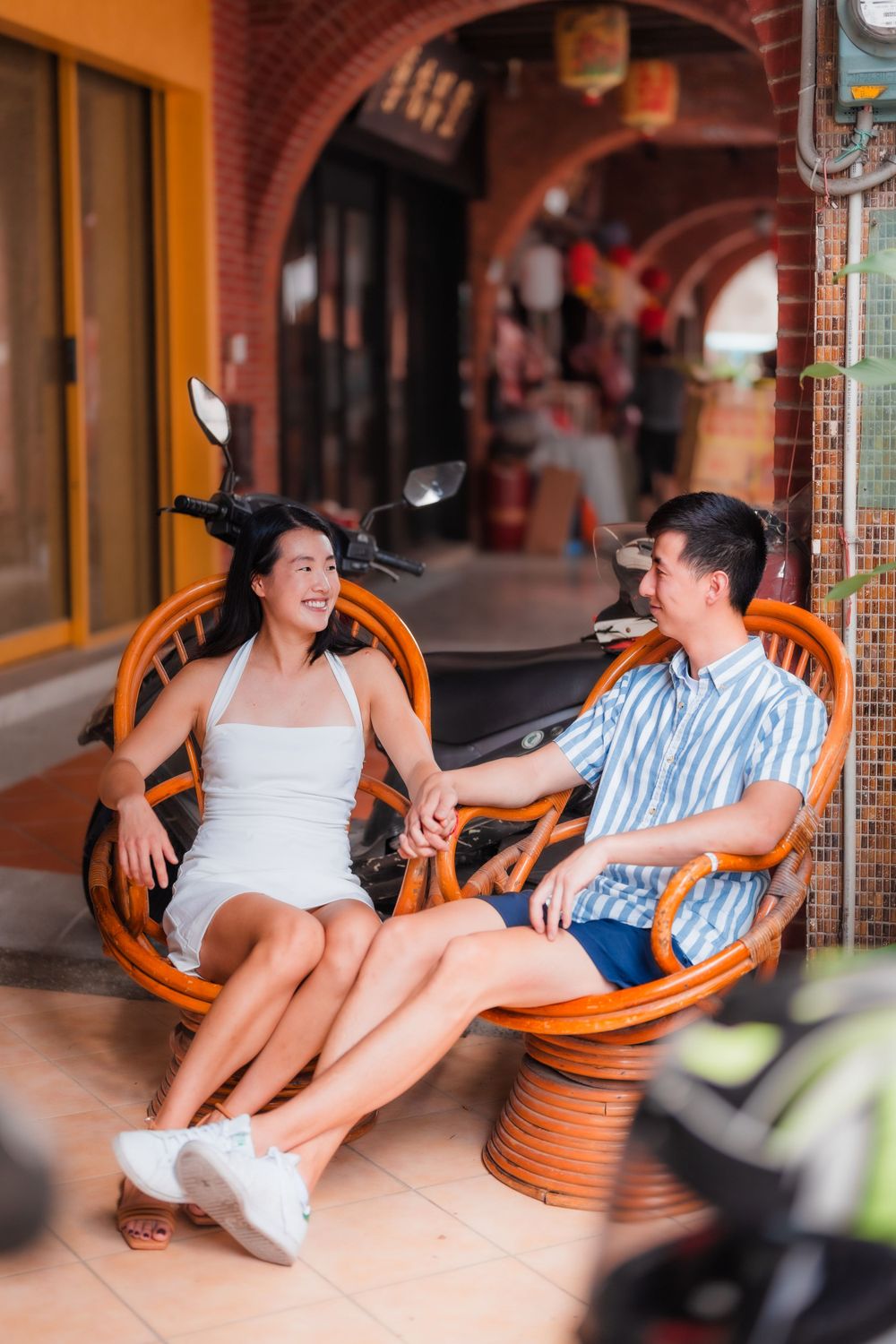 A couple sitting on the chairs at Dihua Street in Dadaocheng, Taipei City.