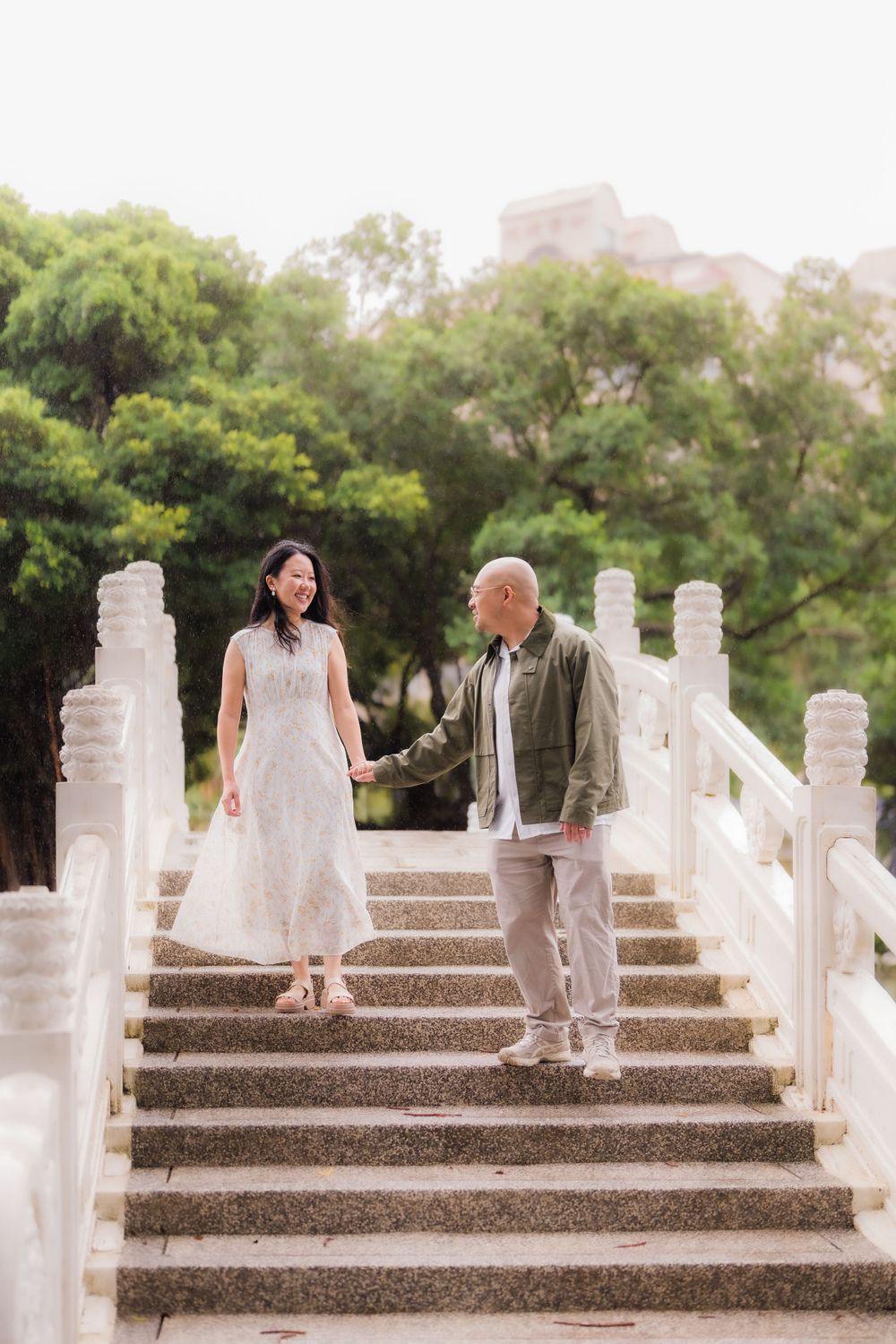 A couple on the stairs of a bridge at CKS Memorial Hall in Taipei City.
