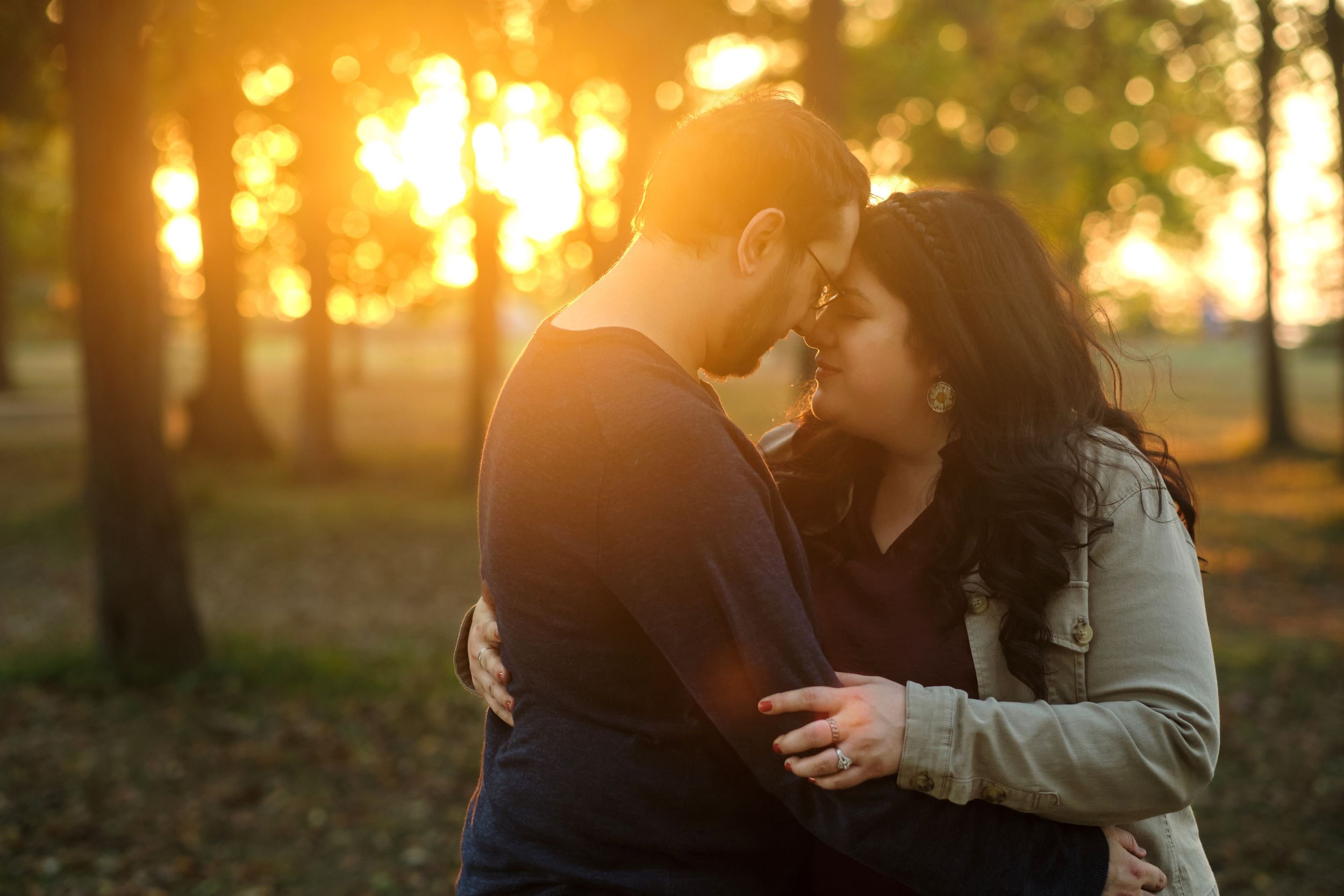 A couple embraces for a portrait during the sunset