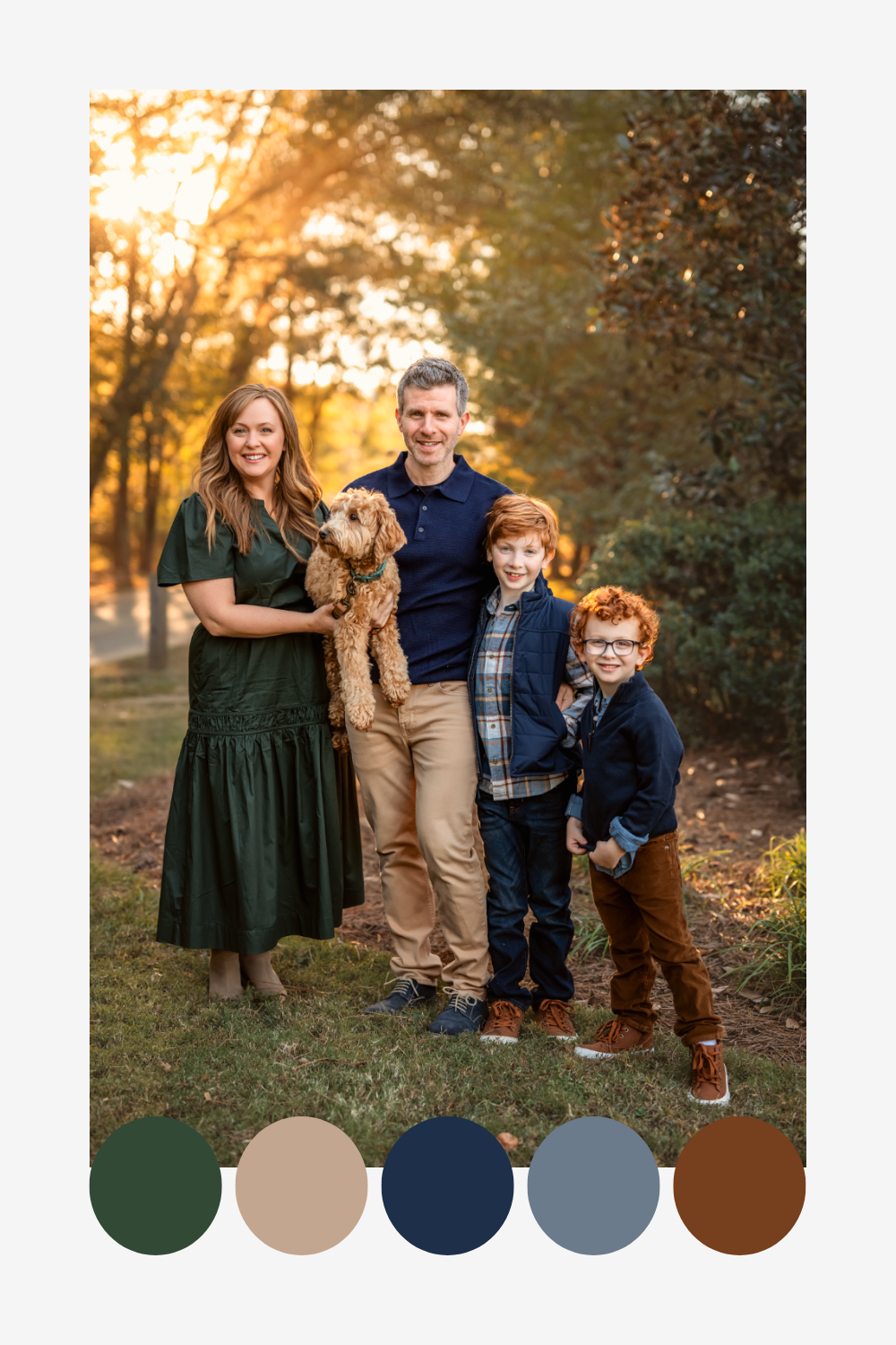 An outdoor family portrait with a golden retriever in warm autumn sunlight showing complementary green, tan, navy and brown tones.