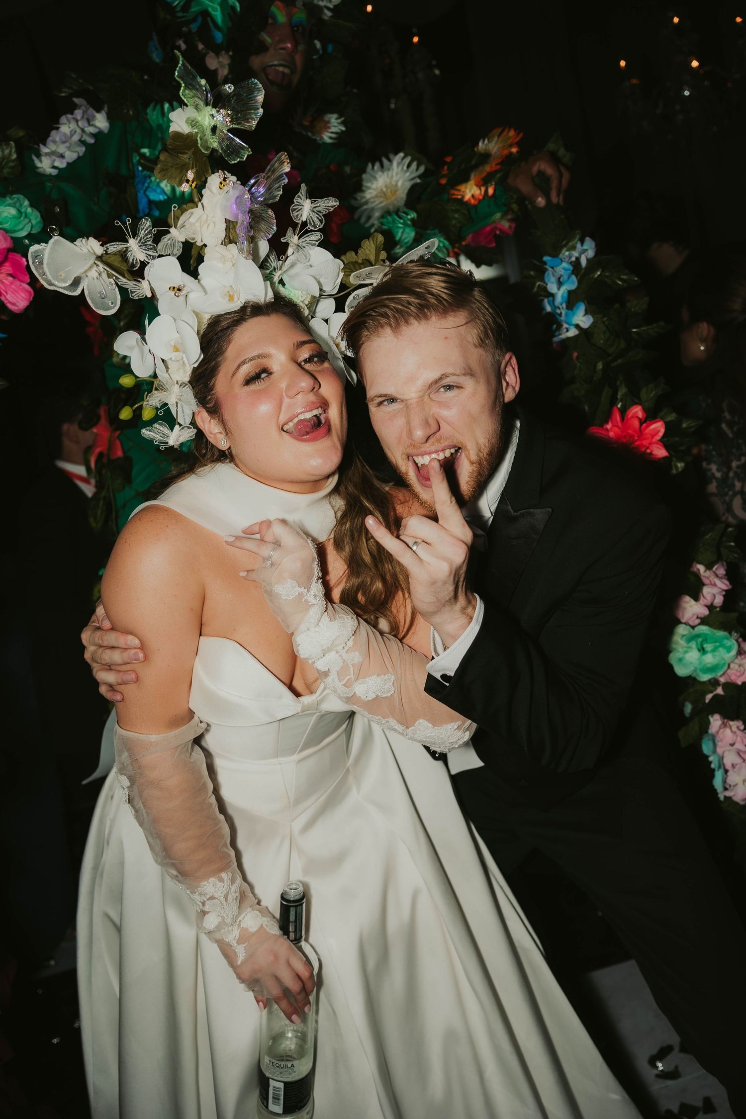 Wedding celebration with floral decor and colorful lights creating a festive atmosphere in El Salvador