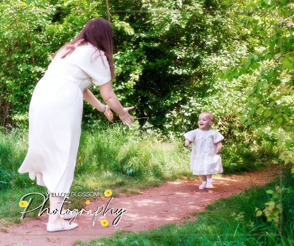 A magical moment captured on a dirt path surrounded by blooming flowers and green foliage in a peaceful garden setting.