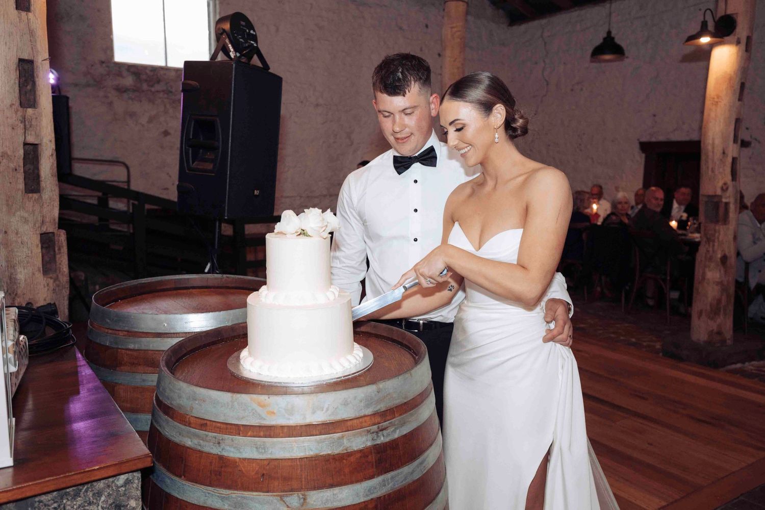 Happy married couple cutting cake  at Warrawong Estate, Victoria