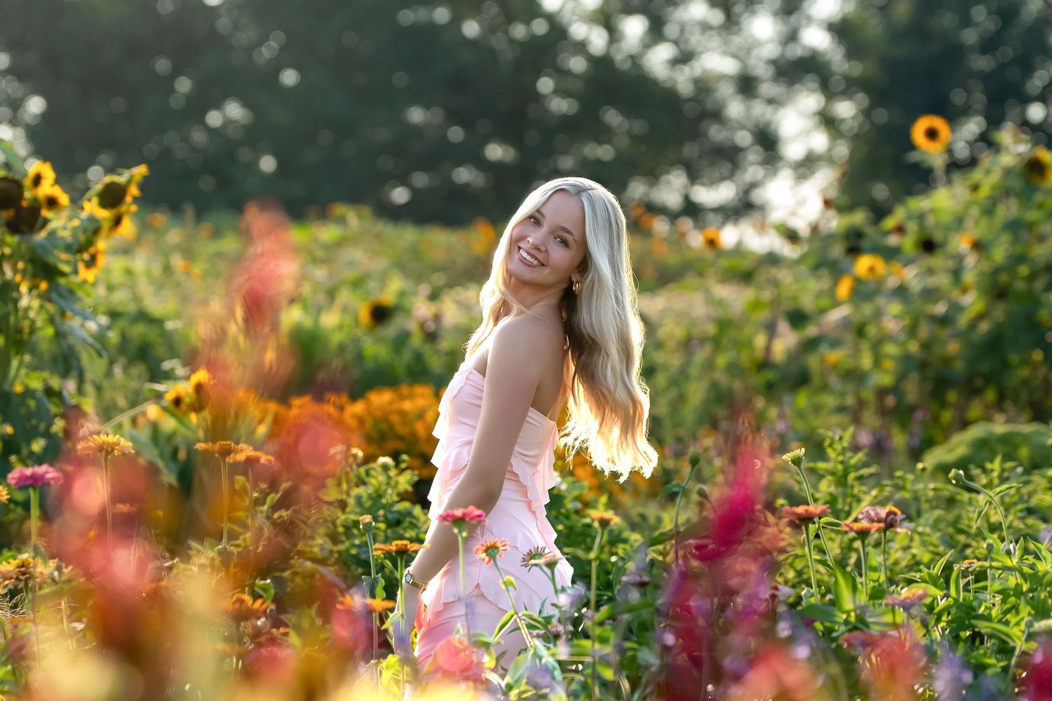 A floral dress stands out against a vibrant purple lavender field on a sunny summer day.