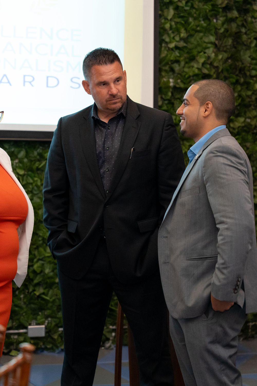 Formal event gathering with attendees in business attire networking.
