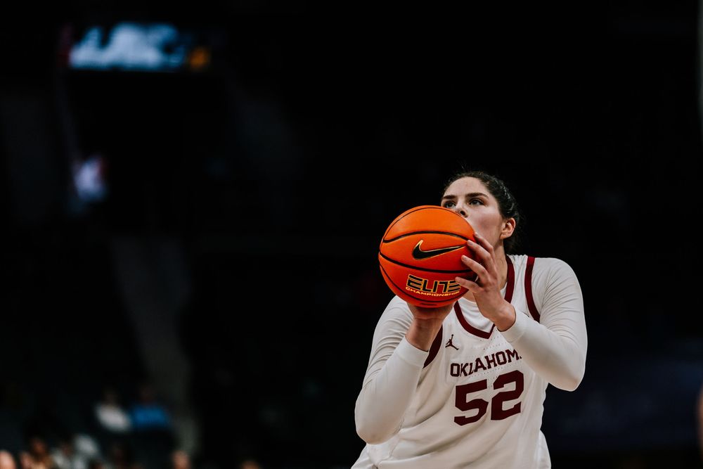 Oklahoma women's basketball player #52 prepares for a free throw during a college game.
