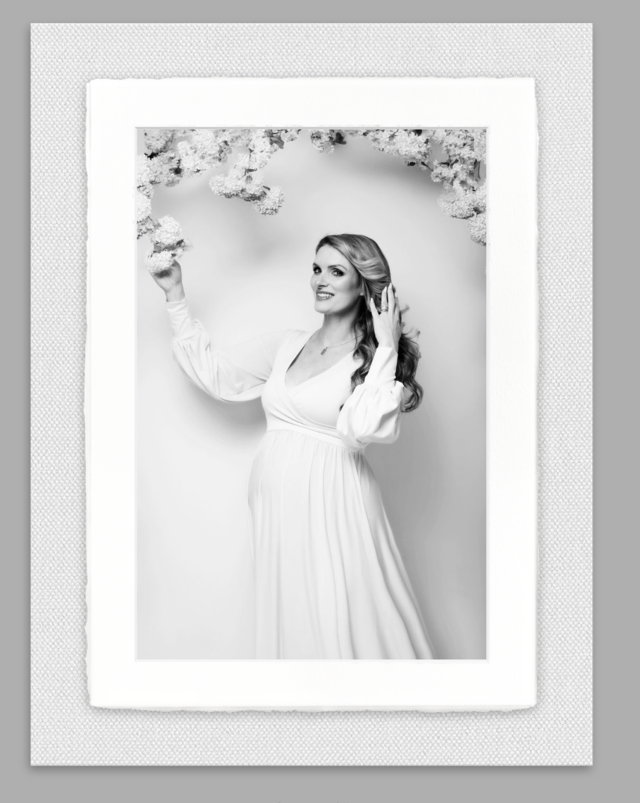Framed wall art with black-and-white maternity photo.