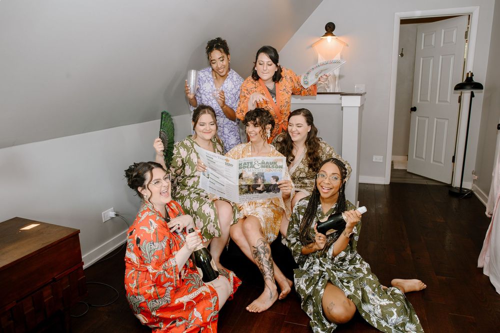 Friends and family gather for casual group photos in a cozy home setting with tropical floral dresses.
