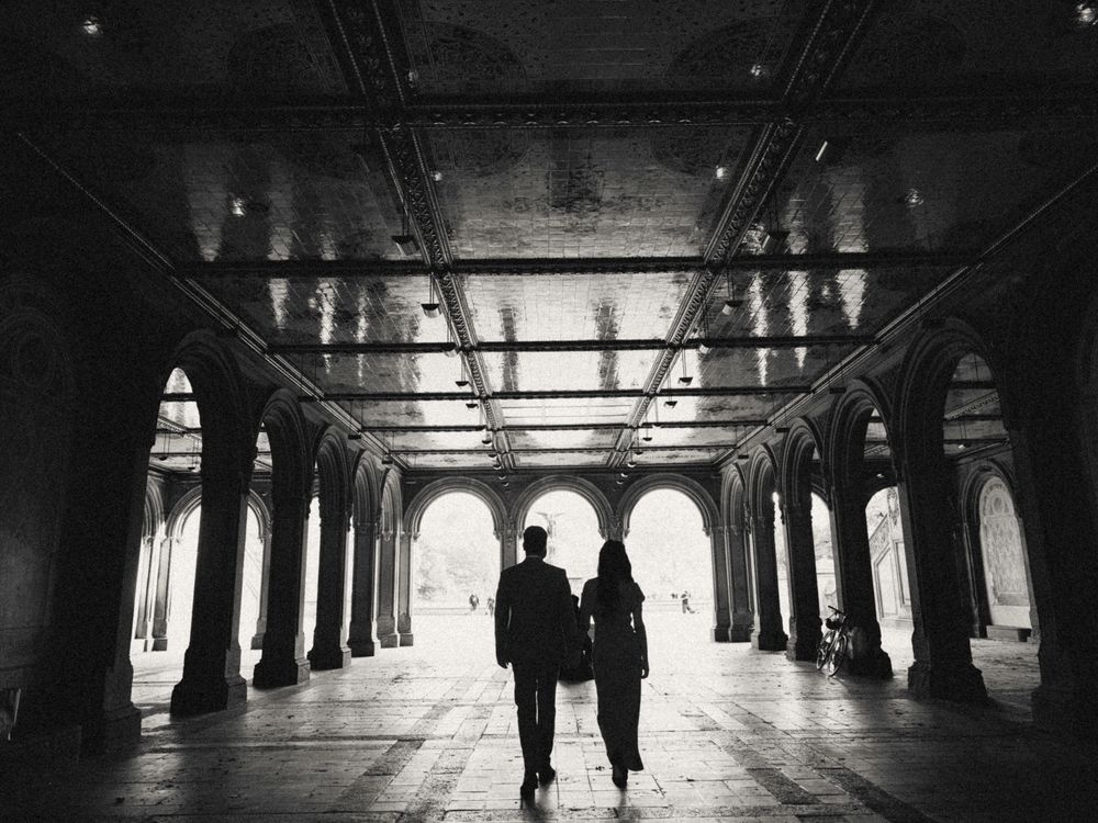 A black and white photo series shows dark silhouettes walking through a dimly lit tunnel with dramatic shadows and light.