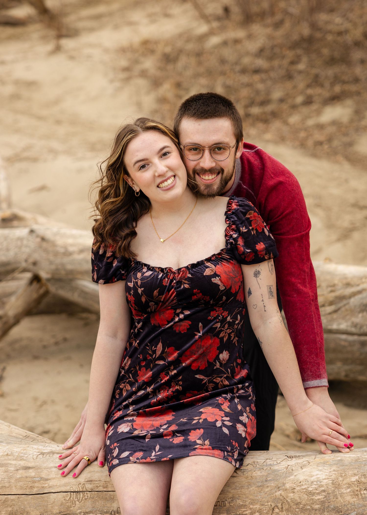 engaged couple taking engagement photos at a lake outside photoshoot
