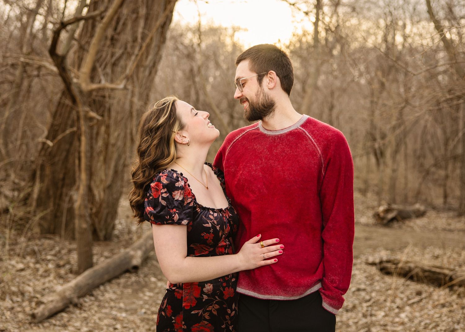 engaged couple taking engagement photos at a lake outside photoshoot