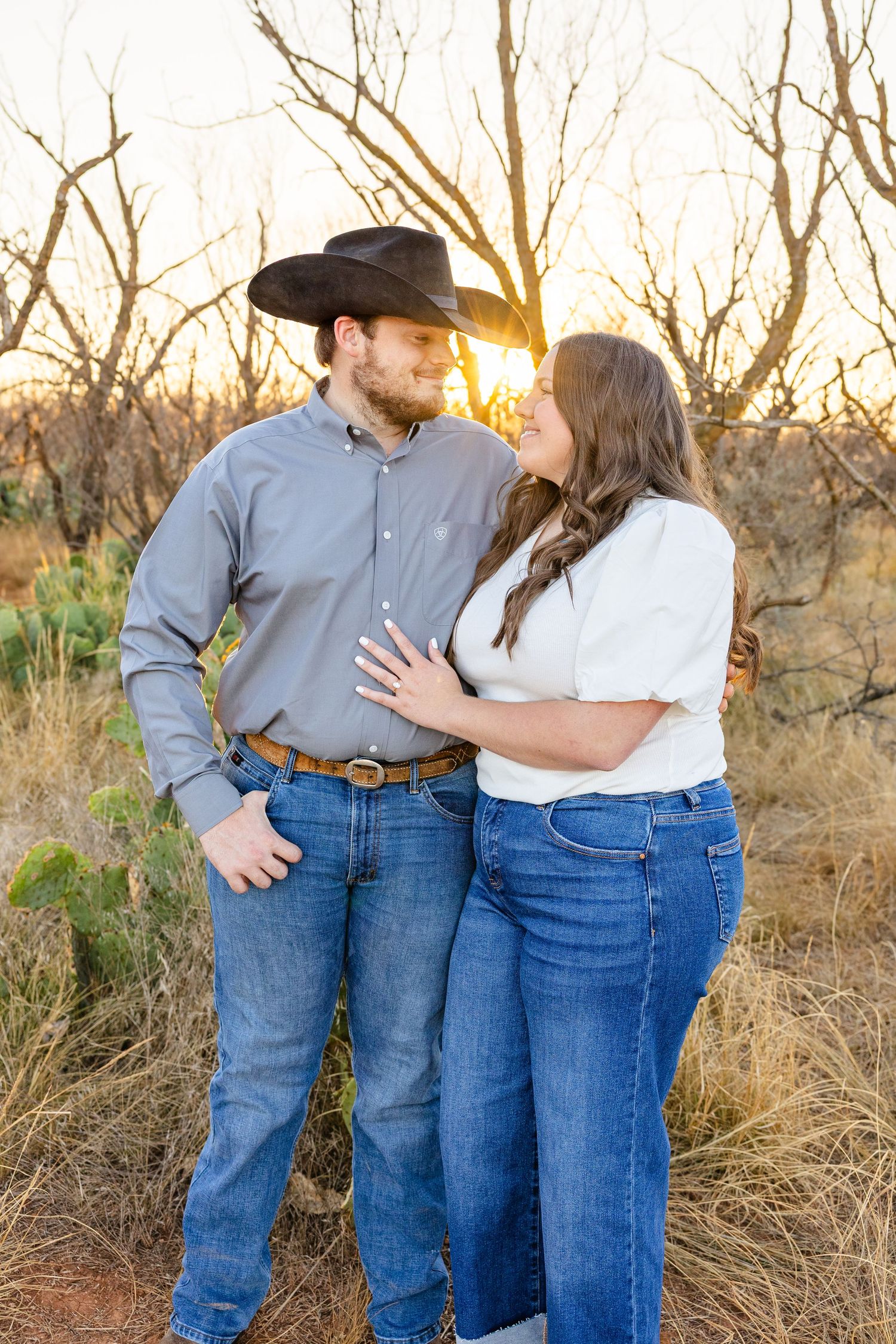 engagement pictures in a field at golden hour in west texas photography session