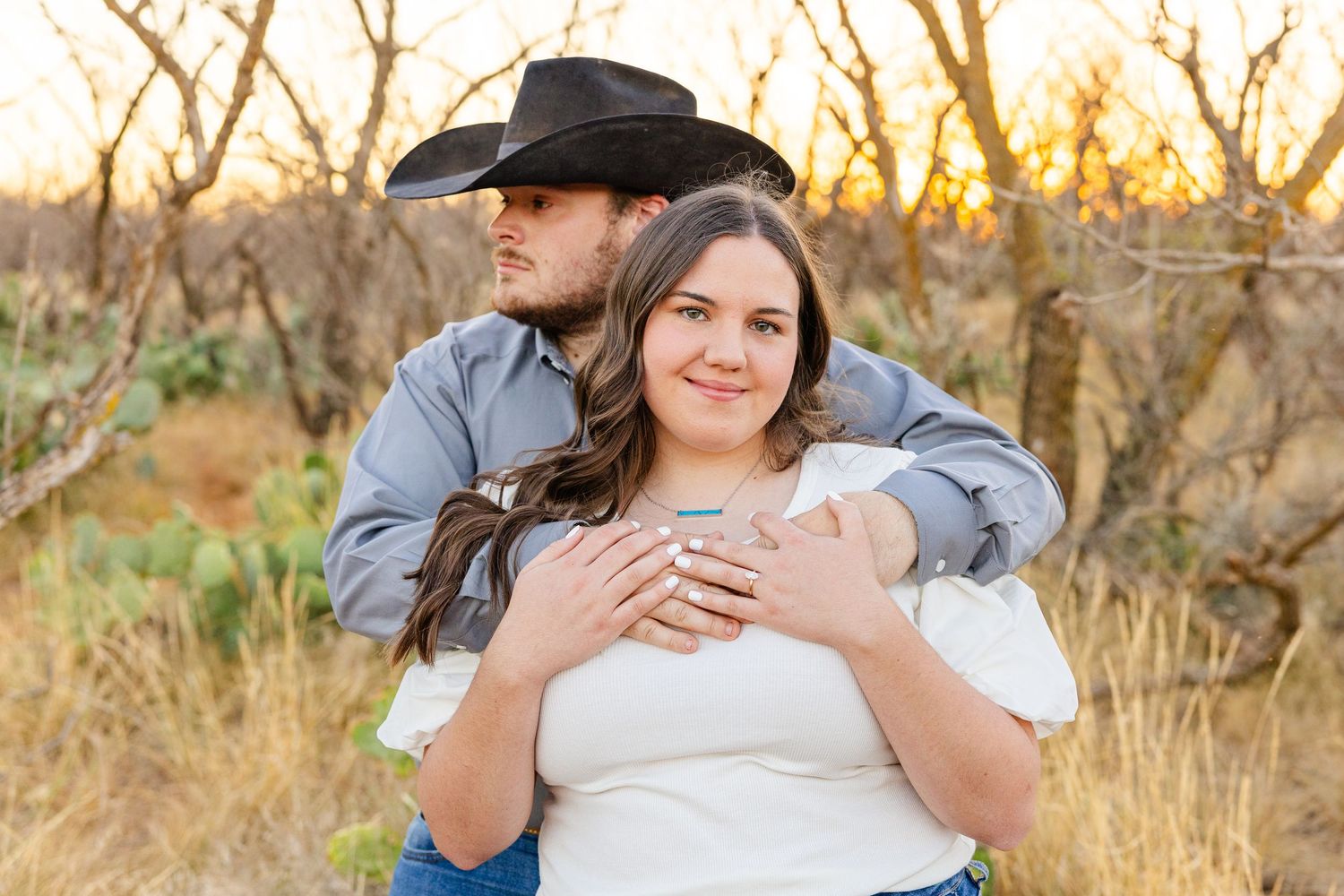 engagement pictures in a field at golden hour in west texas photography session