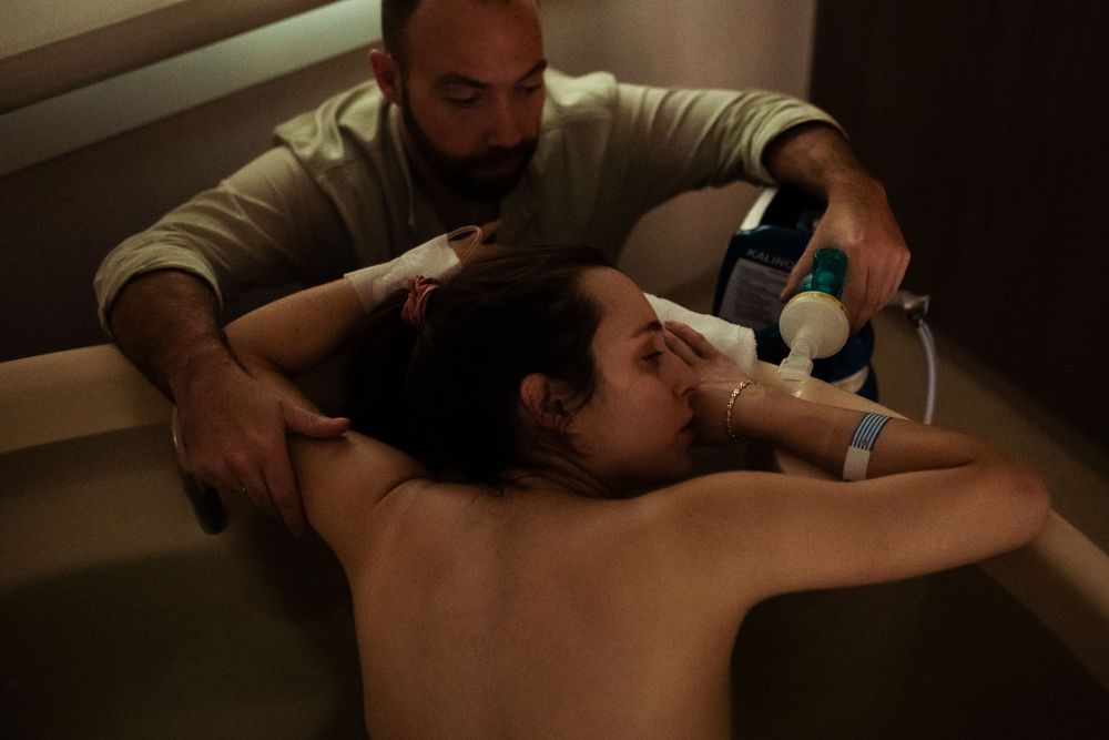 Professional massage treatment being performed in dimly lit spa setting.