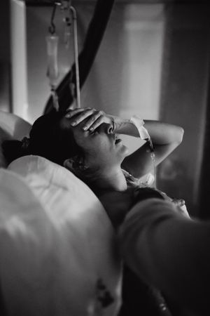 Black and white series of intimate labor moments in a medical setting.