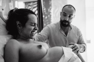 Black and white sequence showing emotional support during labor process.