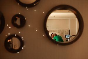 Warm-toned view of hospital room with circular mirror and ambient lighting.