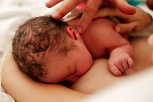 Series of photos showing newborn baby receiving medical care on white hospital sheets.
