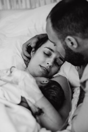 Intimate black and white photograph of a tender moment between two people.