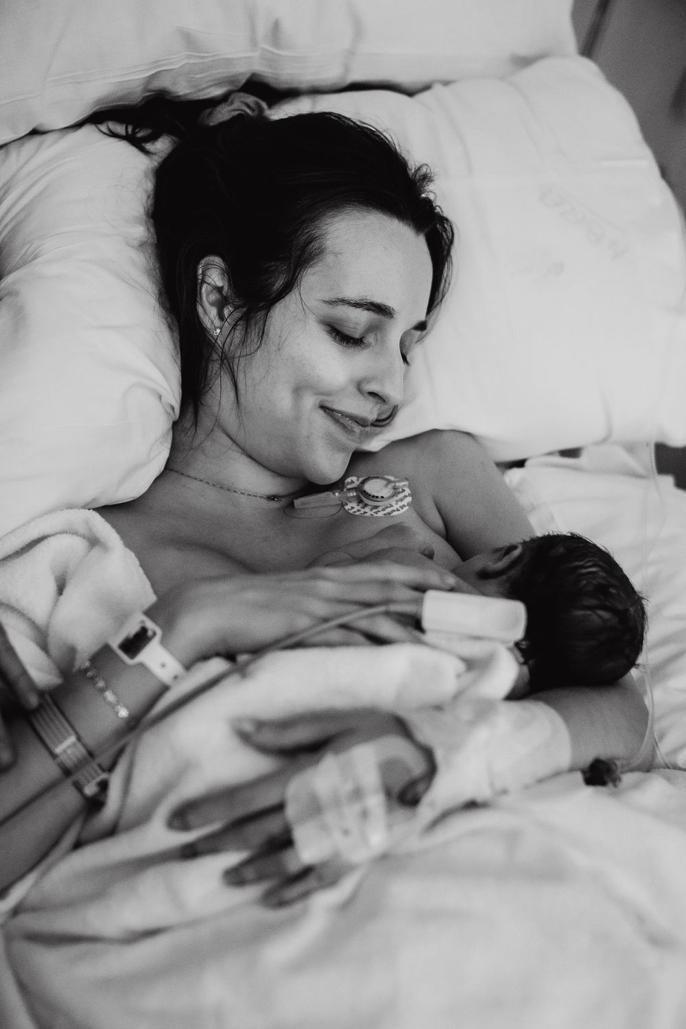 Black and white photograph showing peaceful bonding moment with baby.