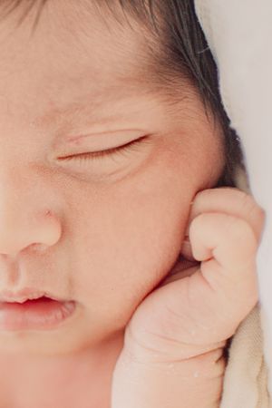 Macro shot of a sleeping newborn baby's delicate features.