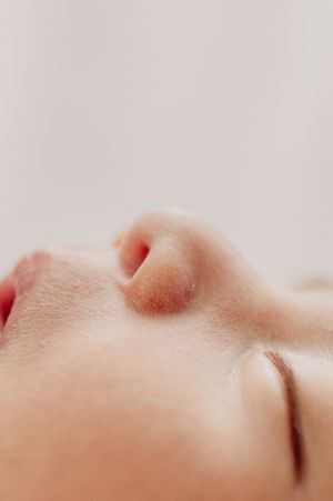 Extreme close-up of a peaceful sleeping baby's nose and lips.