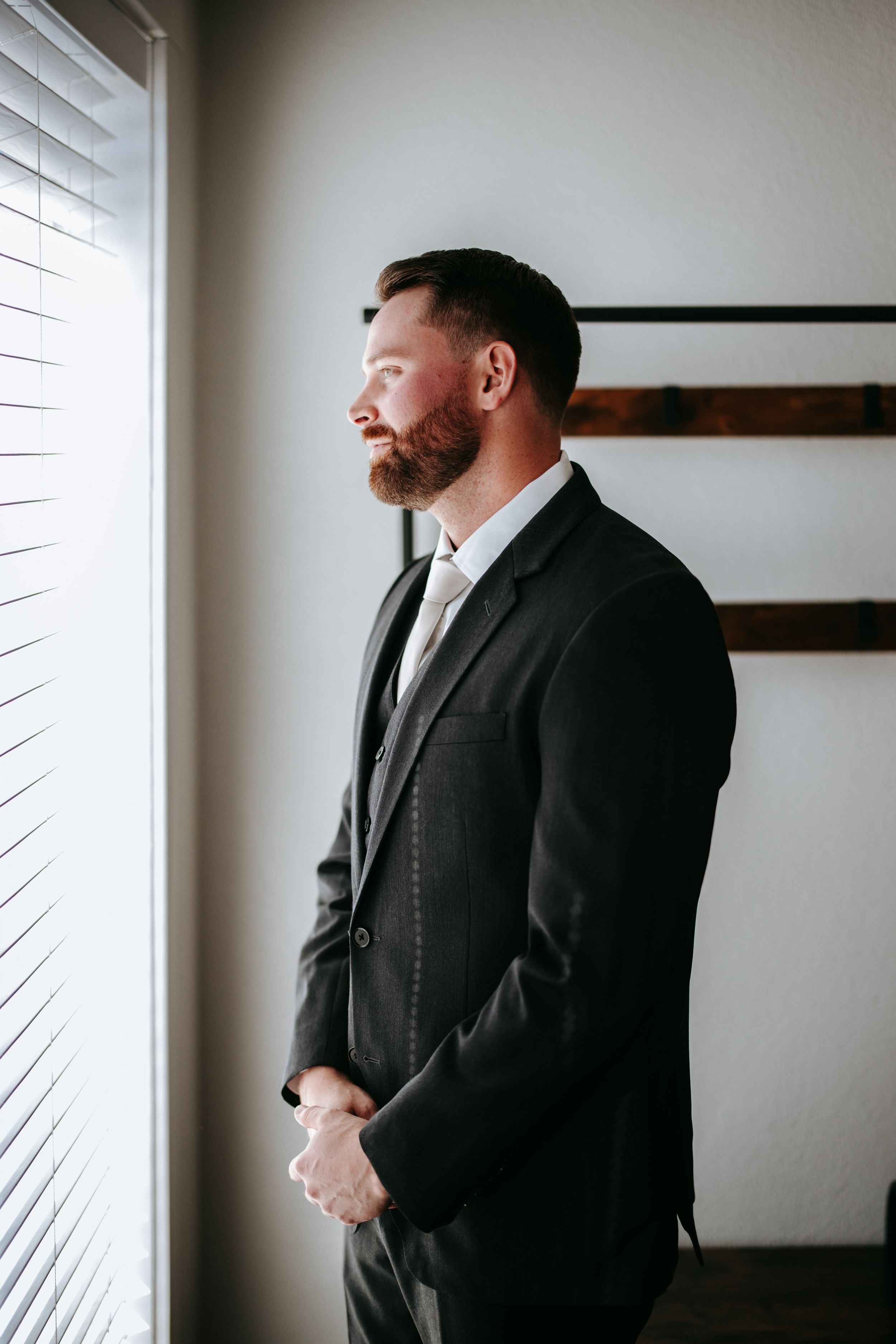Close-up silhouette profile shots of a man in formal black suit and tie.