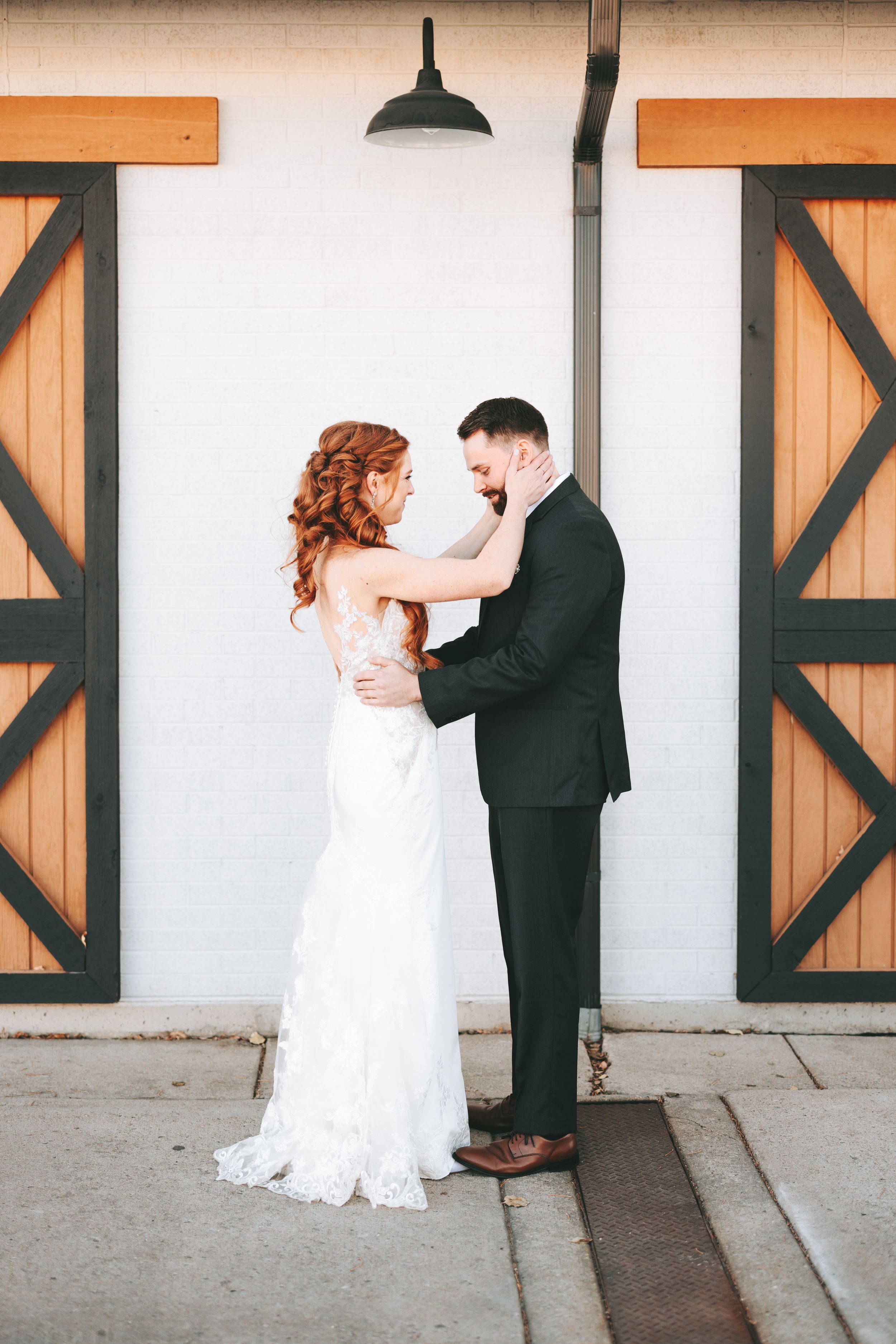 Wedding first look sequence with rustic barn doors backdrop.